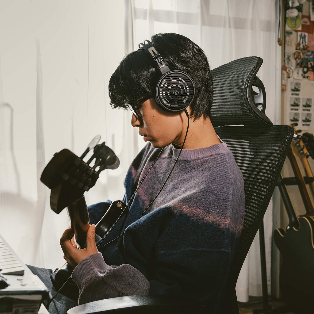 Audio Technica ATH-R30x studio headphones with over-ear design and adjustable headband, shown in black with cushioned ear cups.