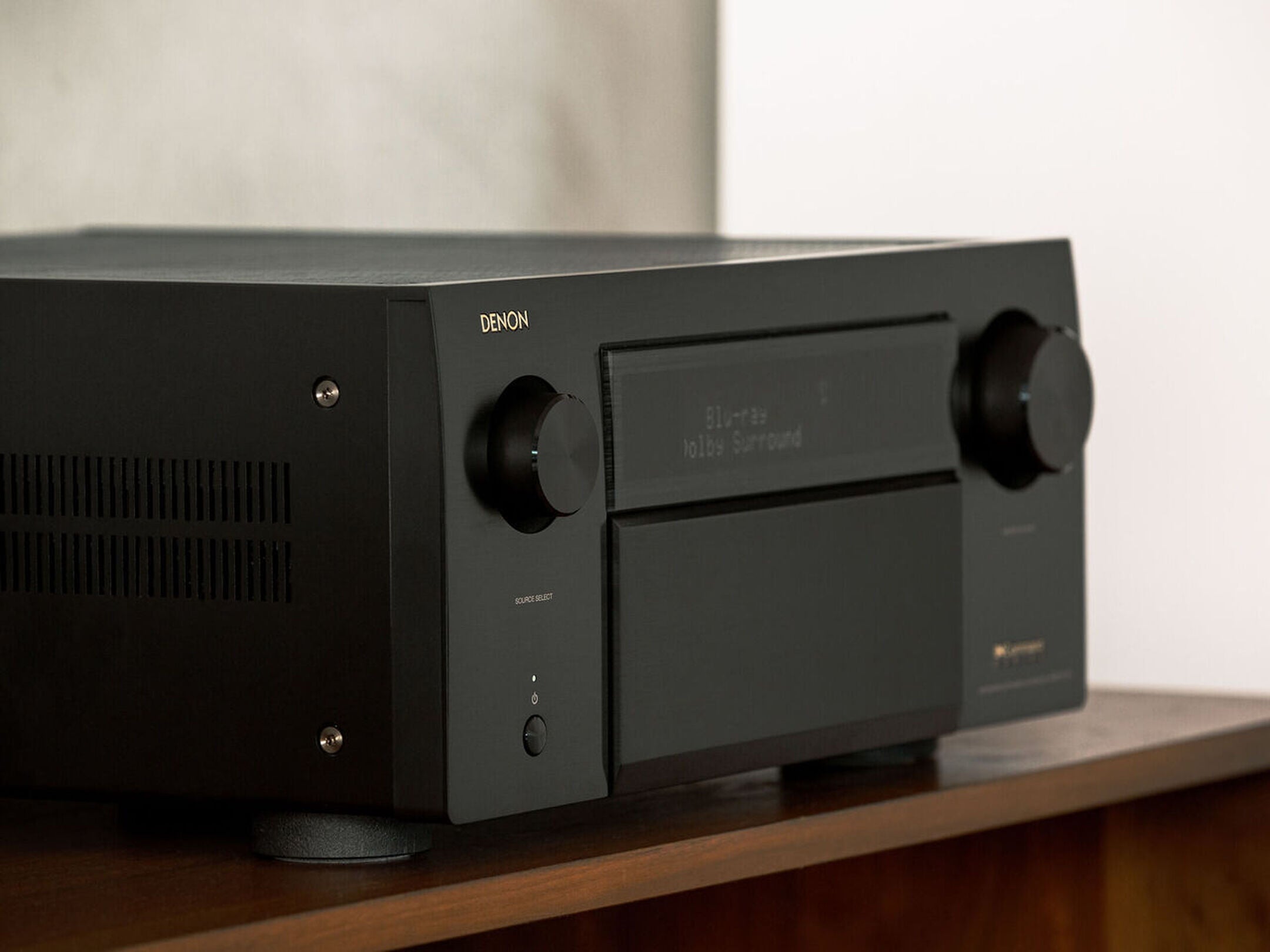 Denon AVC-A1H stereo amplifier with multiple audio input options and sleek design, shown on a modern home entertainment setup.