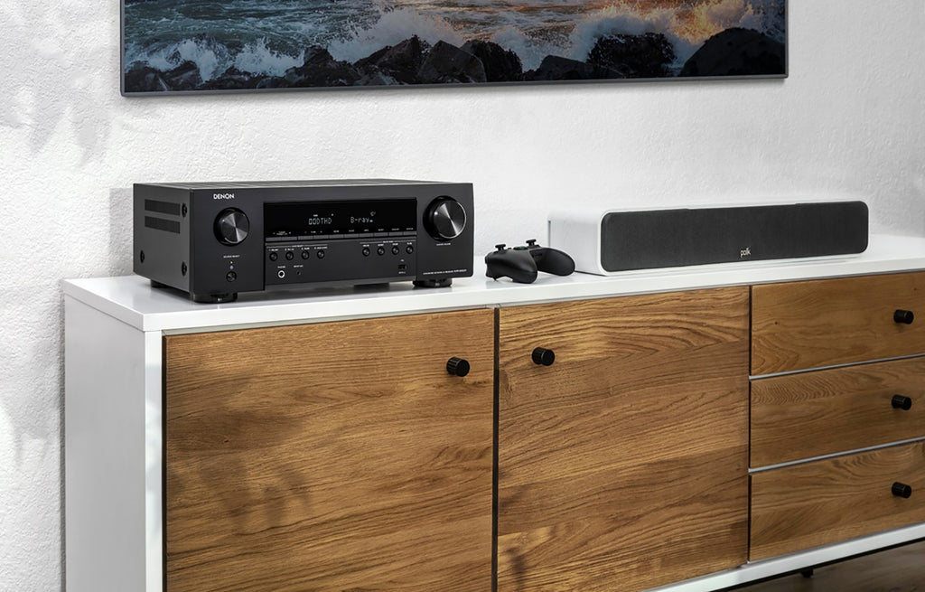 Denon AVC-S660H stereo amplifier with sleek black design and multiple input ports, showcasing front panel controls and display.