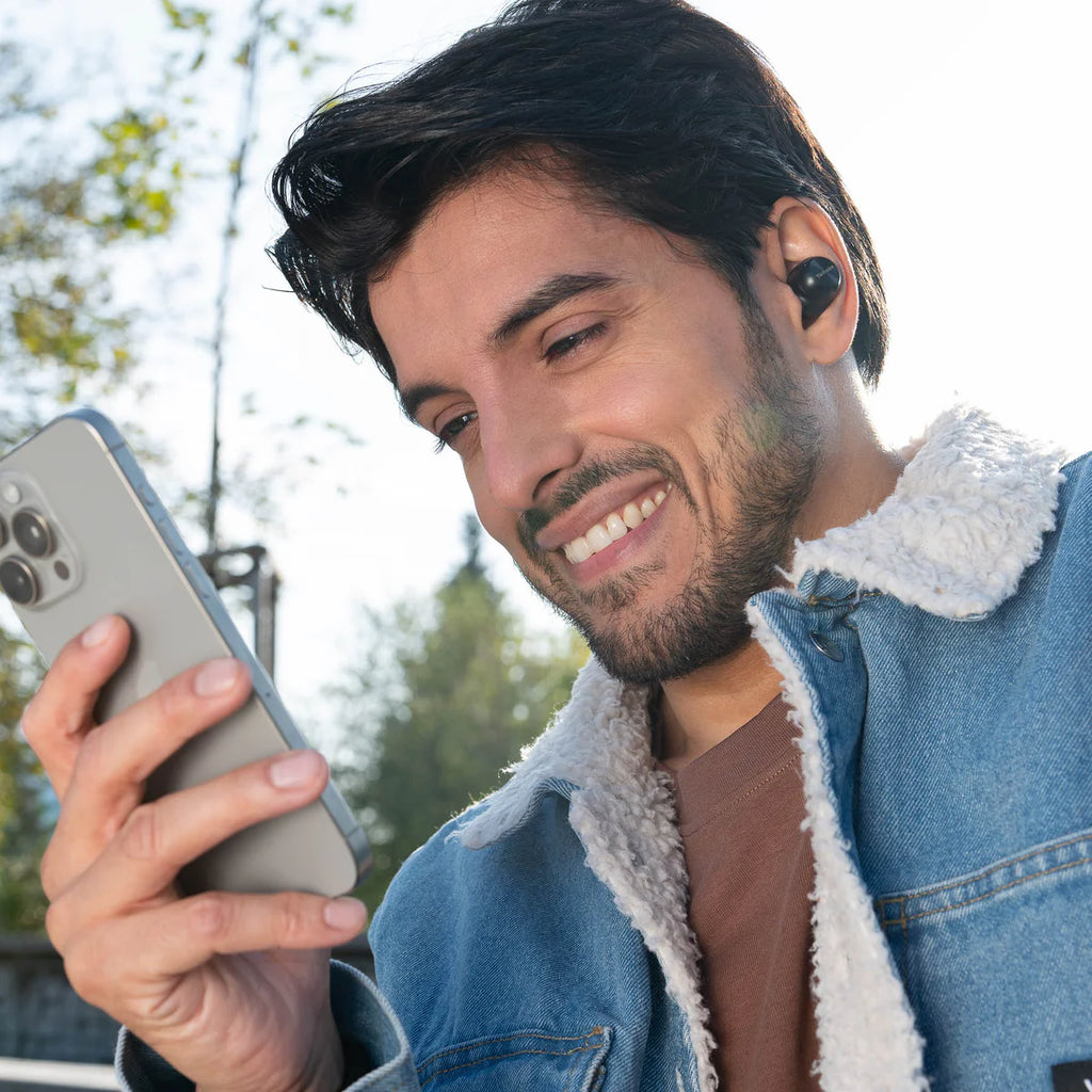 Black Technics EAH-AZ100 wireless in-ear headphones with sleek design and in-ear fit, shown in a lifestyle setting.