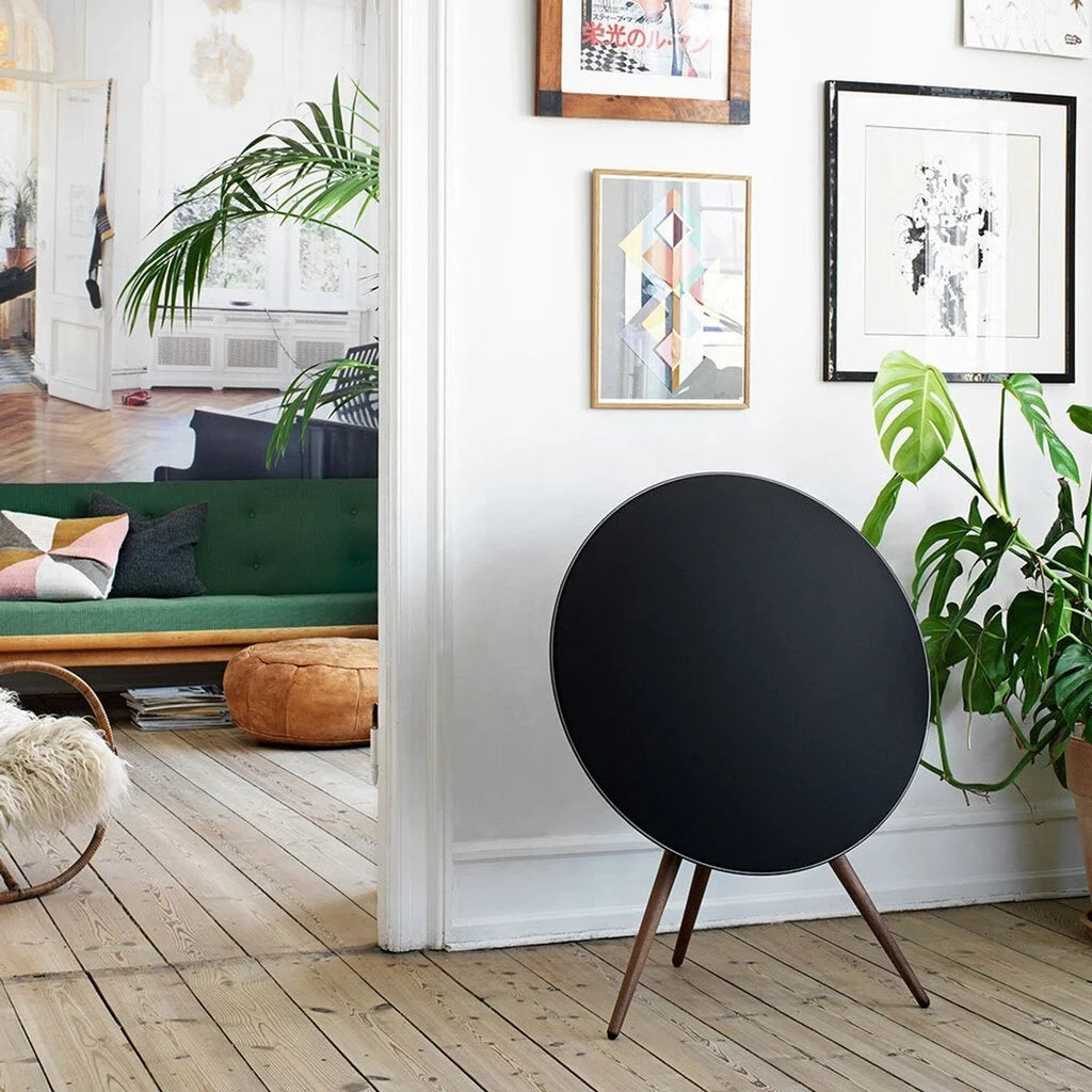 Black Bang & Olufsen Beosound A9 5th Gen wireless speaker with a sleek, circular design and fabric-covered exterior.