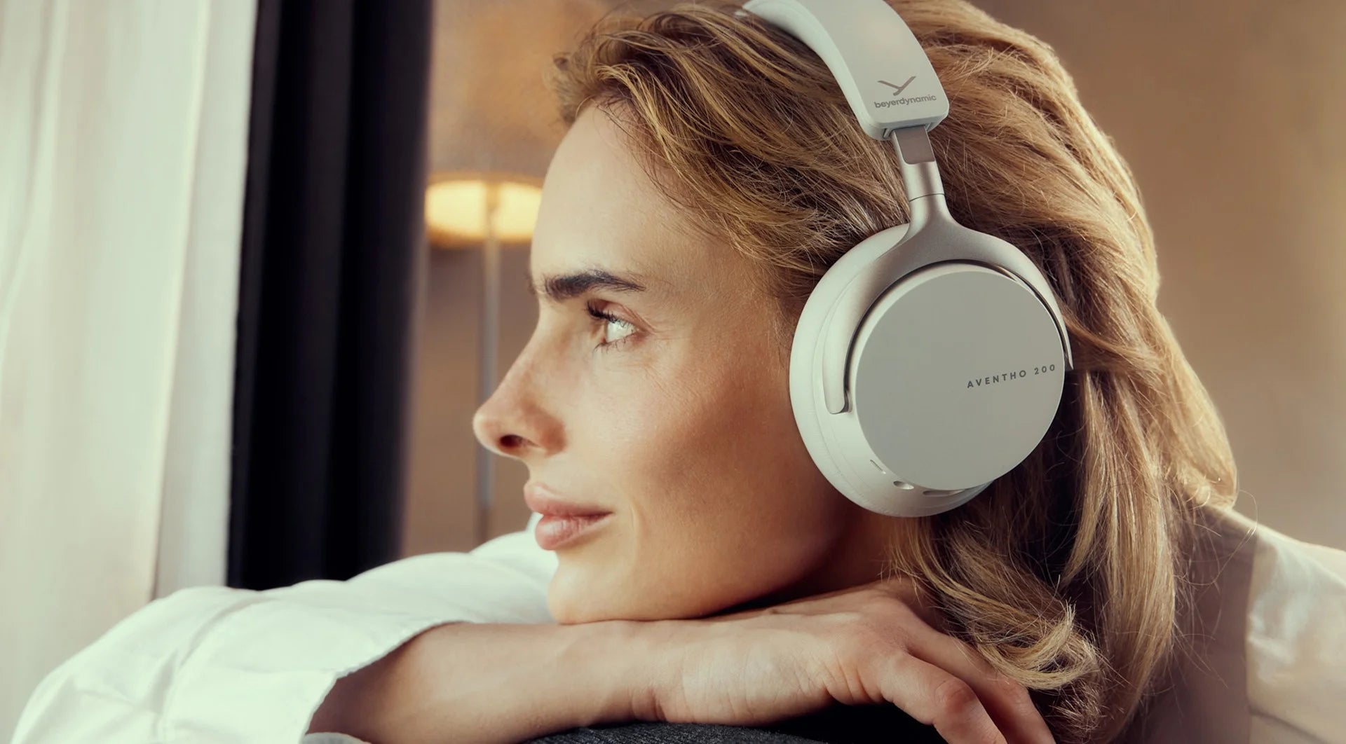 Beyerdynamic Aventho 200 wireless headphones displayed on a banner slider, showcasing sleek black over-ear design and built-in controls.