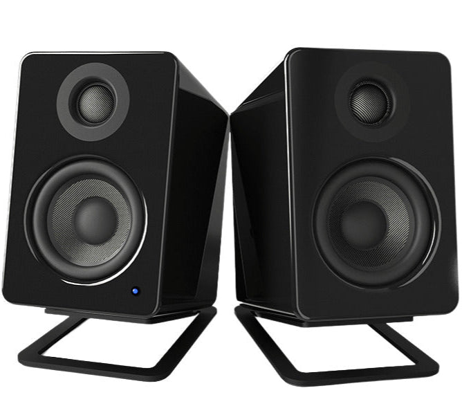 Kanto Audio S2 desktop speaker stands supporting small speakers on a modern desk setup
