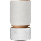 Bang & Olufsen Beosound Balance wireless speaker with white marble finish and flexible design, showcasing modern audio equipment.