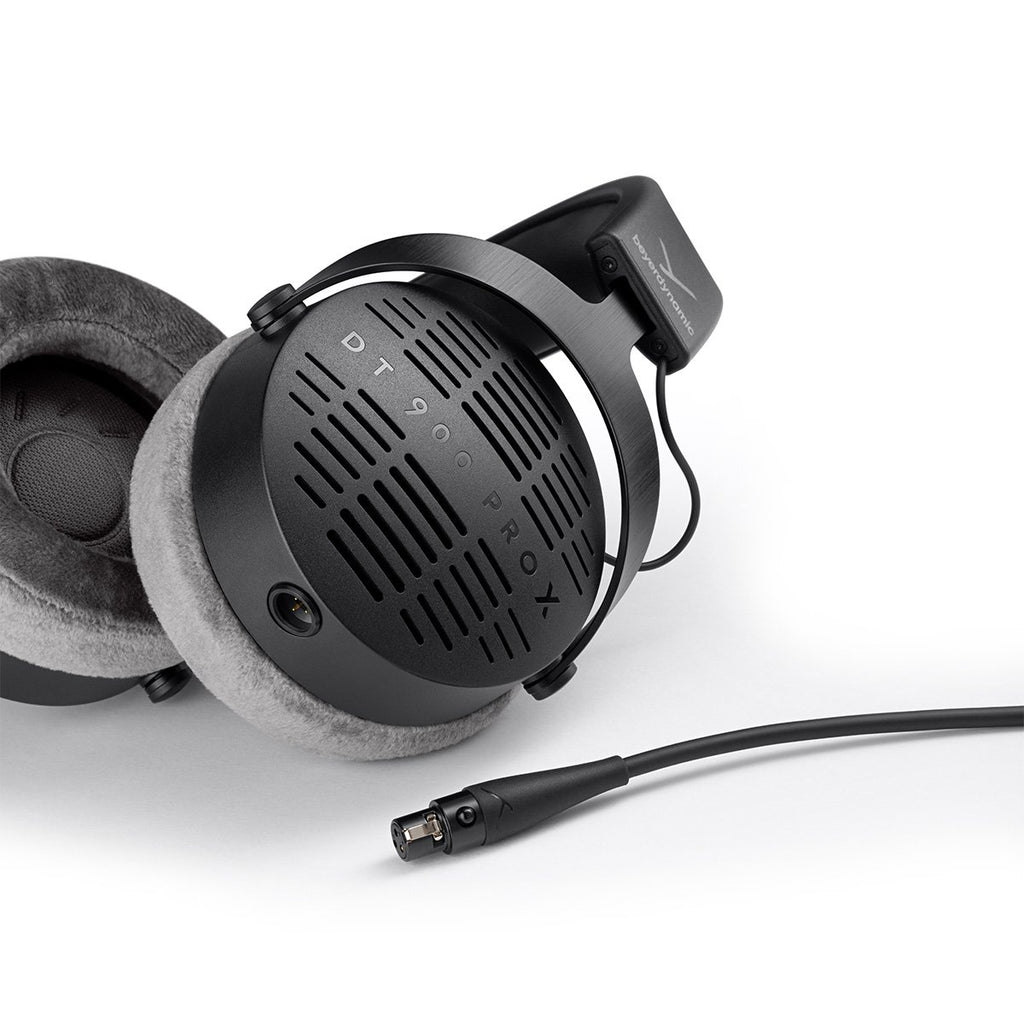 Beyerdynamic DT 900 Pro X studio headphones shown from a side perspective with ear cups and adjustable headband.
