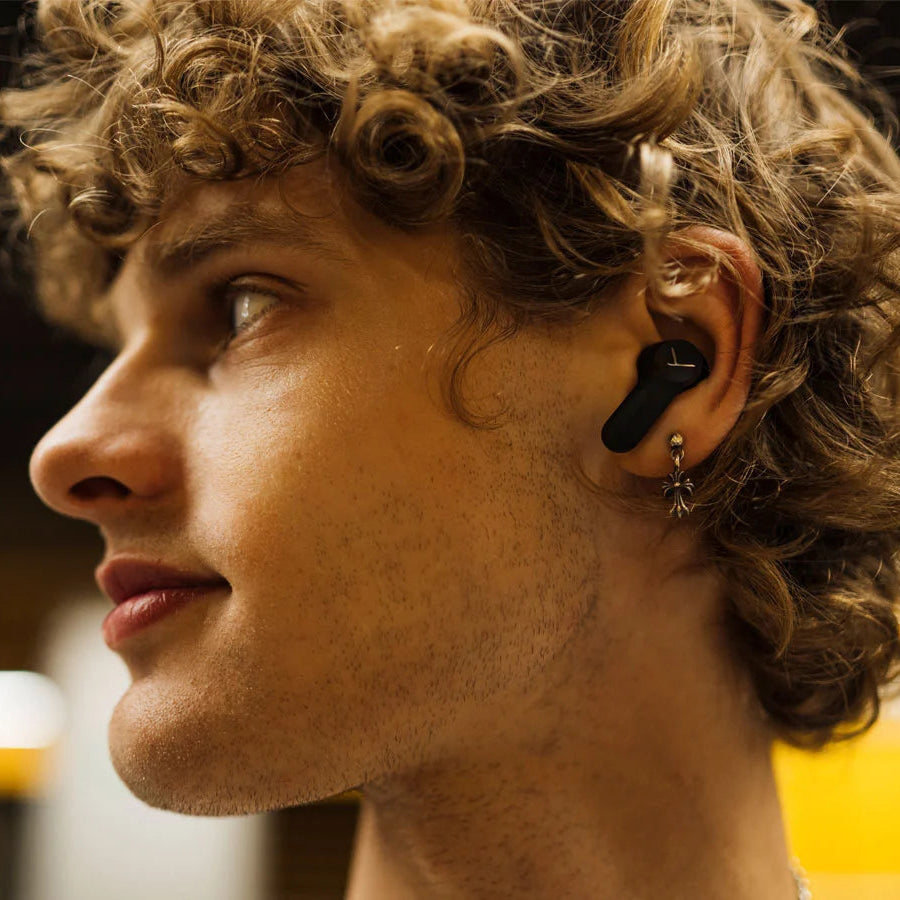 Black Beyerdynamic Amiron 100 wireless in-ear headphones with sleek design and comfortable fit, shown in close-up image.