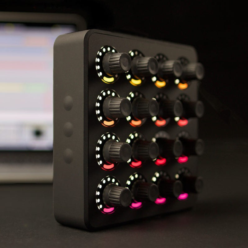 Black DJ TechTools MIDI Fighter Twister MIDI controller with colorful rotary knobs, viewed from a side perspective.