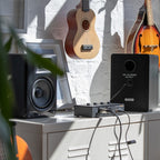 M-Audio BX5 BT active nearfield monitors with sleek black design and front-facing controls for professional audio listening.