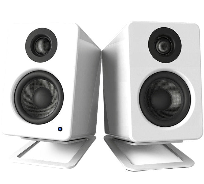 Kanto Audio S2 desktop speaker stands supporting small bookshelf speakers on a desk, with a sleek black finish and sturdy design.