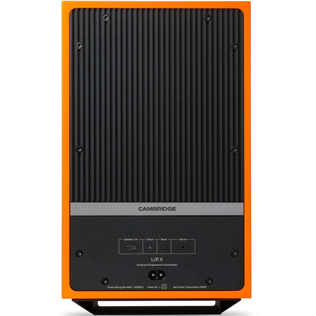 Cambridge Audio L/R X active bookshelf speakers in vibrant orange with black speaker grilles and wood finish accents.