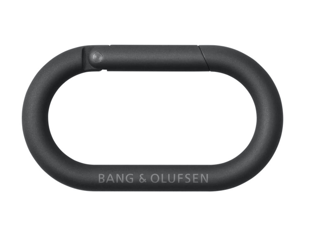 Bang & Olufsen Beosound Explore portable speaker with carabiner attachment, showing front view with textured design and control buttons.