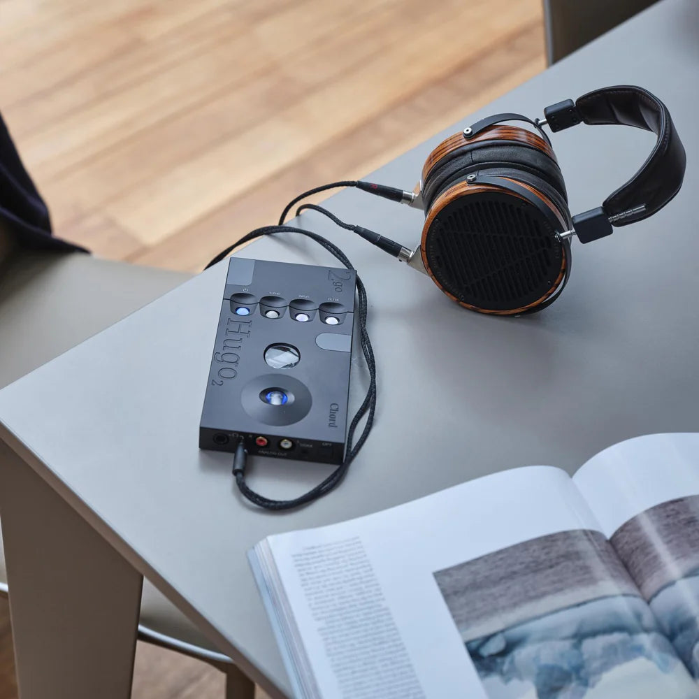 Black Chord Electronics 2go portable music player with Audeze LCD-3 headphones in a lifestyle setting.