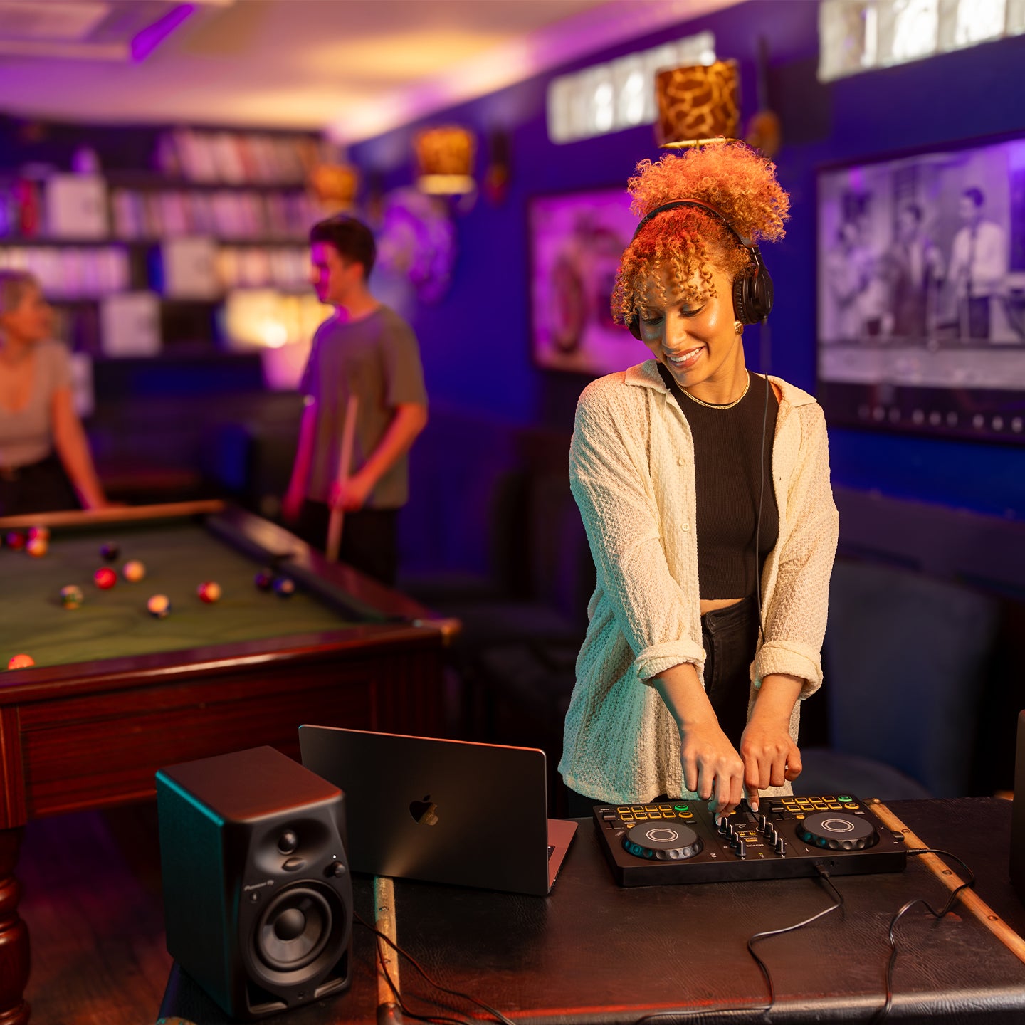 AlphaTheta DDJ-FLX2 DJ controller with jog wheels, mixer faders, and colorful performance pads on a sleek black surface.