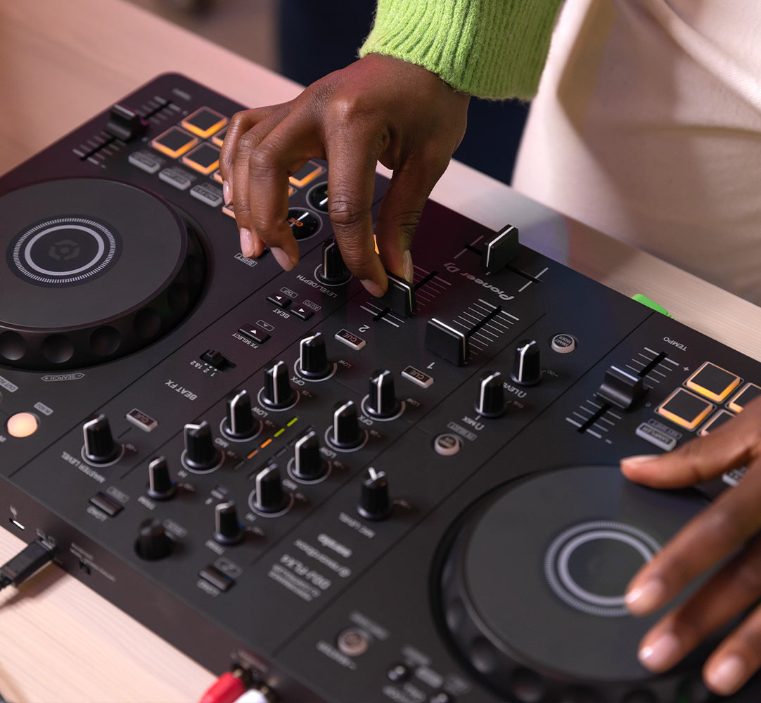 Pioneer DJ DDJ-FLX4 DJ controller with jog wheels, faders, and control panels for mixing and DJing.