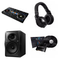 Pioneer DJ DDJ-REV7 DVS Master DJ controller in a music studio setup with control knobs and jog wheels.