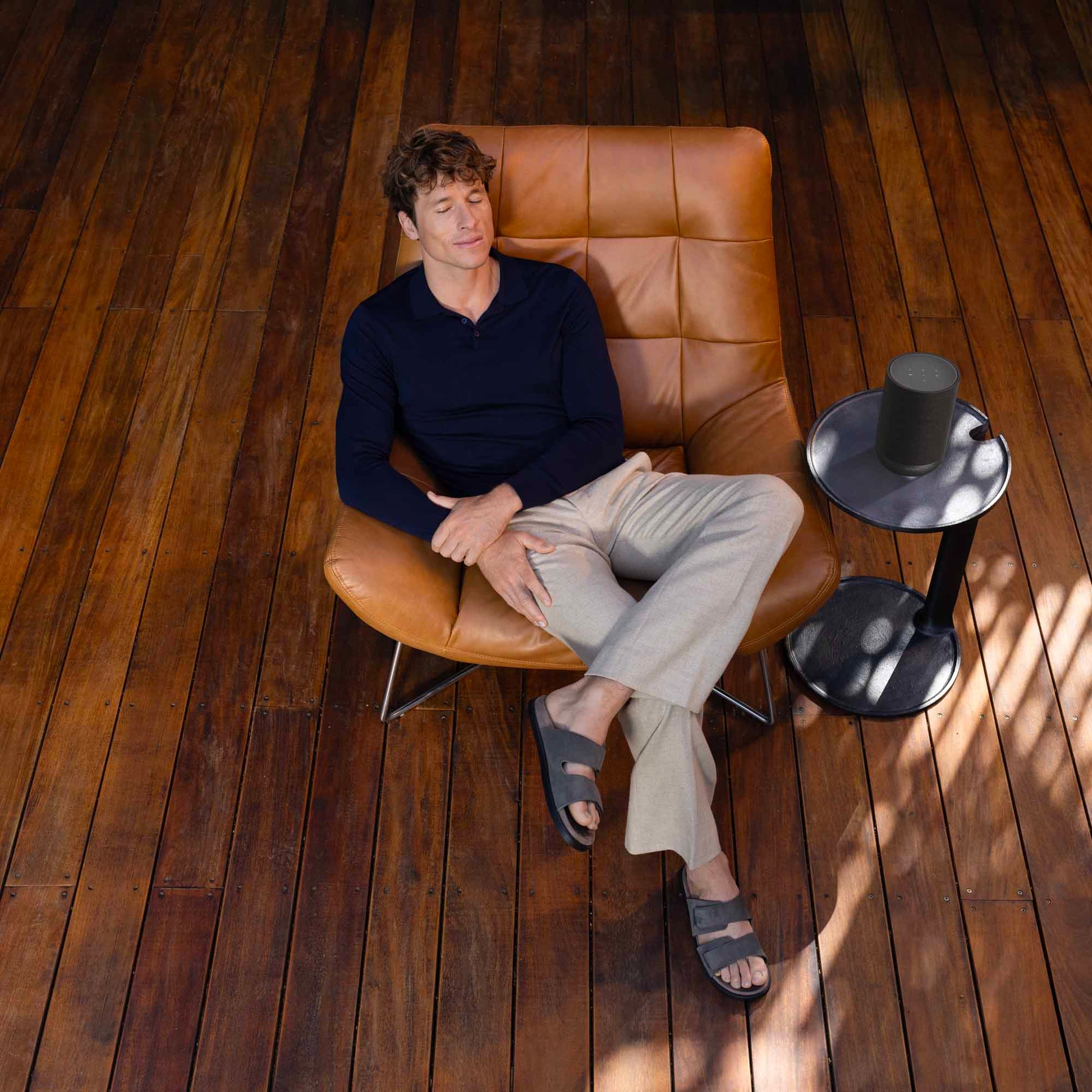 Denon Home 200 wireless speaker in charcoal color, showcasing its sleek design and compact size.