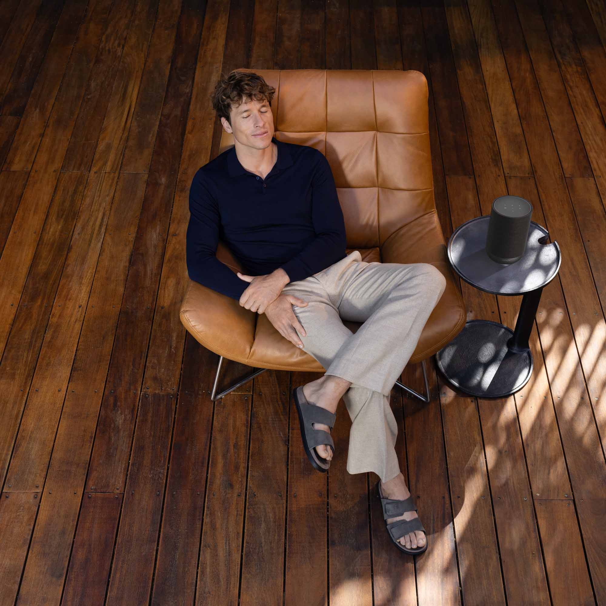 Denon Home 200 wireless speaker in charcoal color, showcasing its sleek design and compact size.