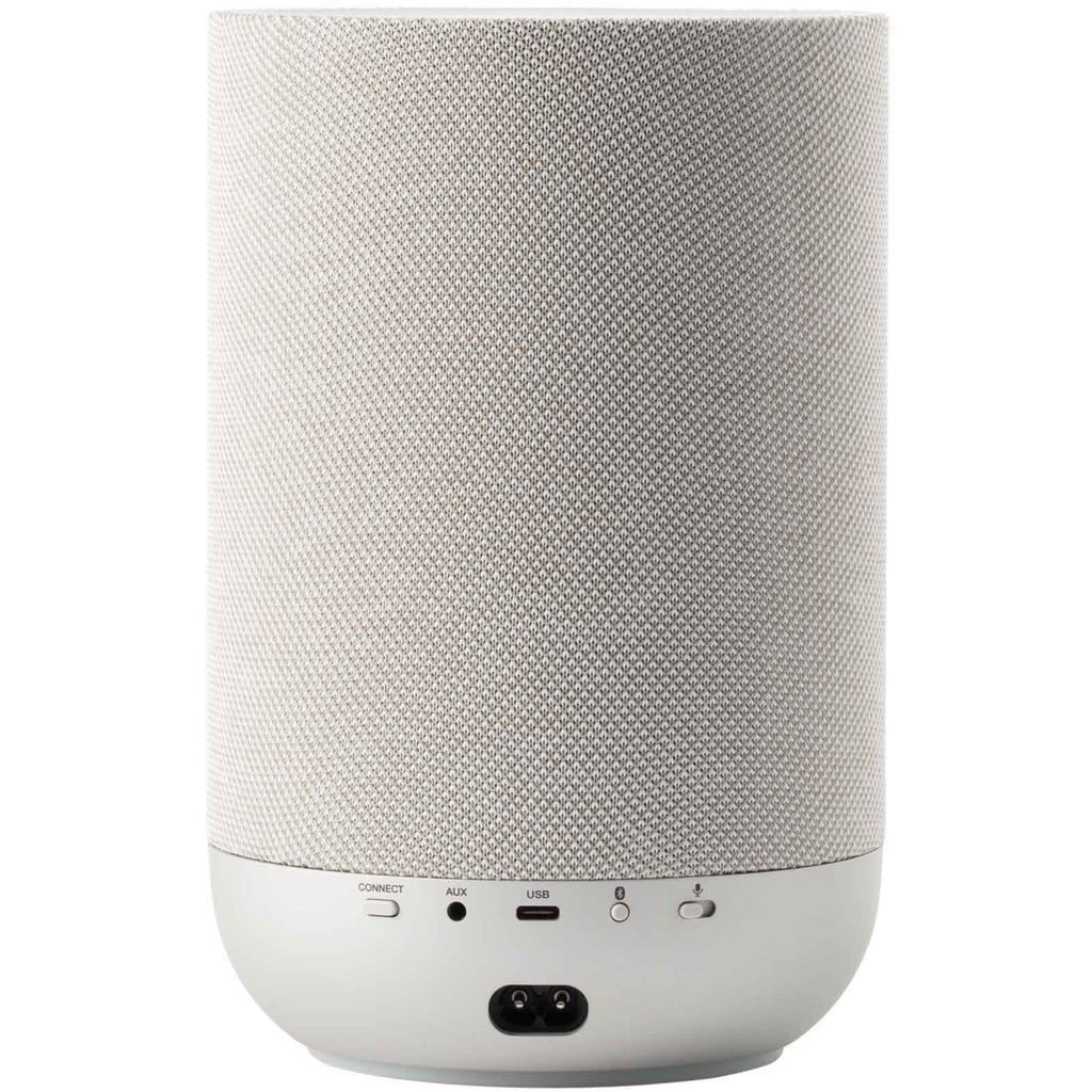 Denon Home 200 wireless speaker in stone color, compact design with fabric grille and control buttons on top.