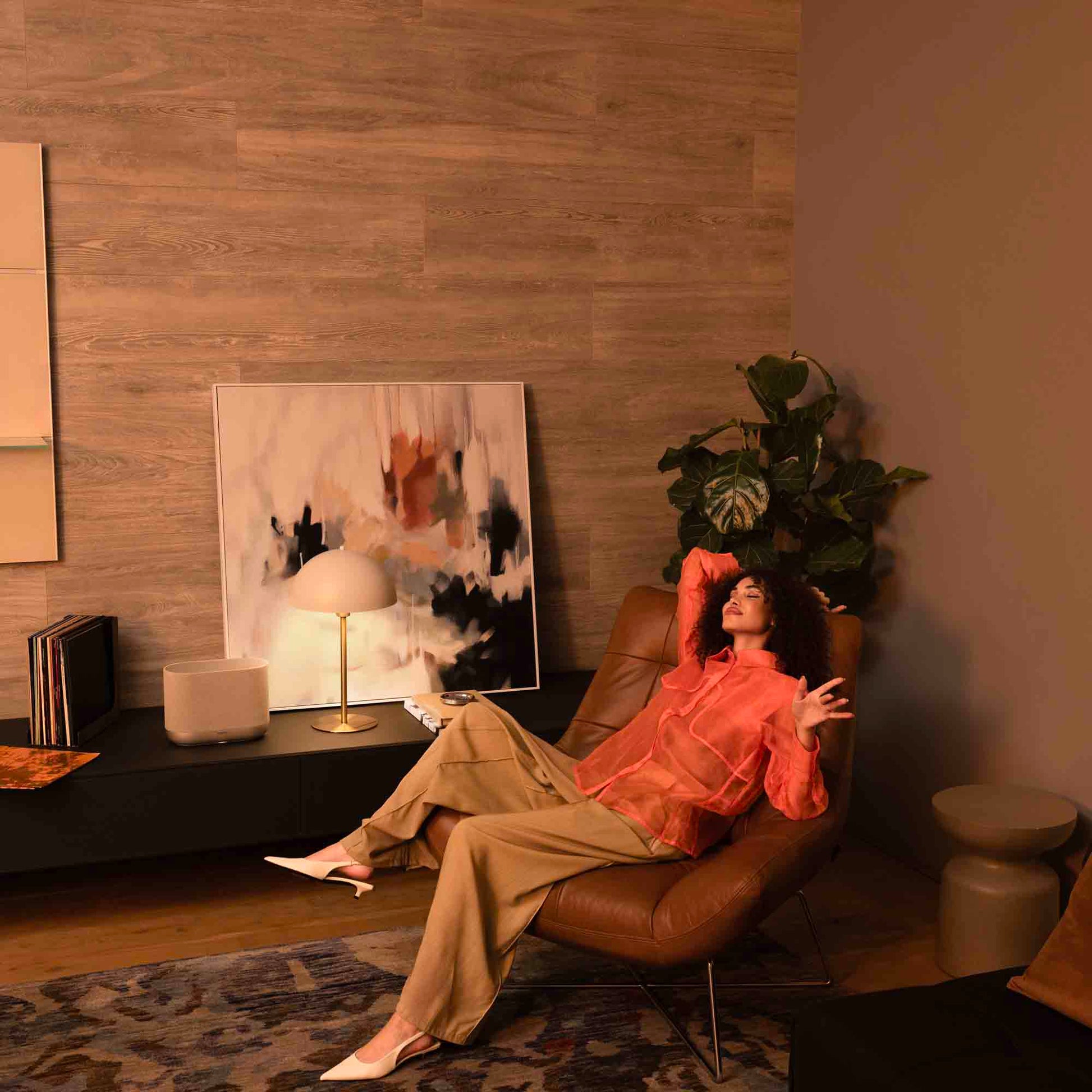 Denon Home 400 wireless speaker in stone color, showcasing sleek design and compact size with control buttons on top.