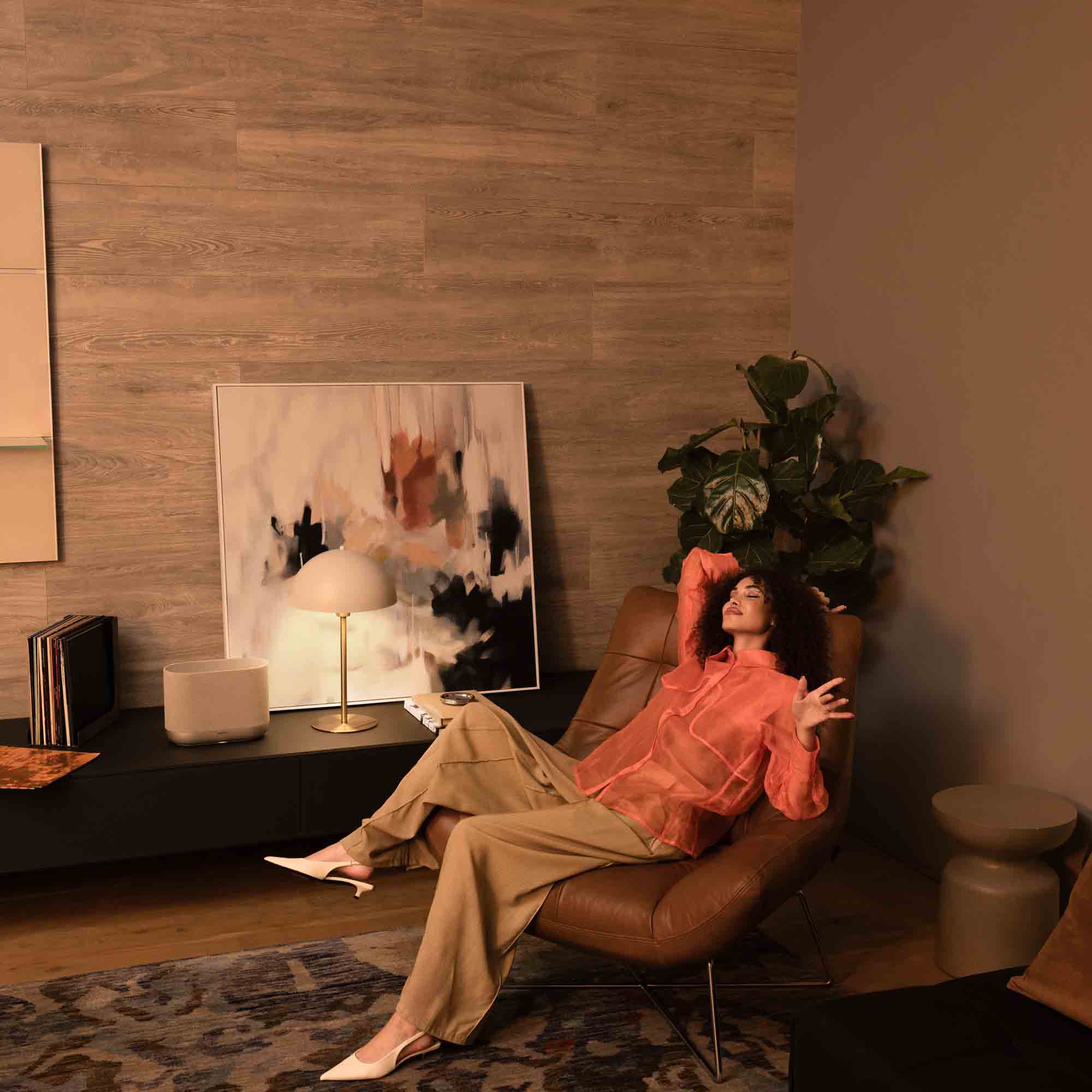 Denon Home 400 wireless speaker in stone color, showcasing sleek design and compact size with control buttons on top.