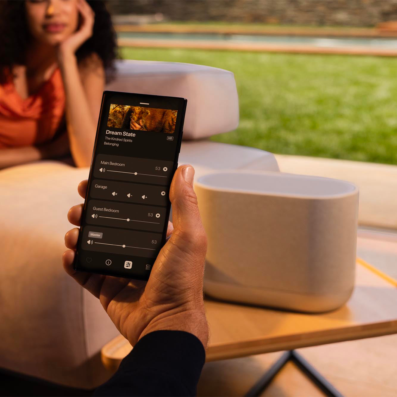 Denon Home 400 wireless speaker in stone color, showing its sleek design and compact size.