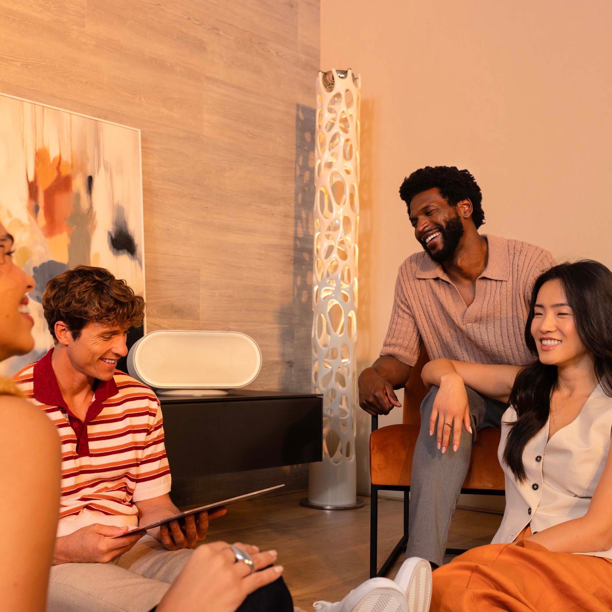 Denon Home 600 wireless speaker in stone color, showcasing its sleek design and compact size for premium audio.