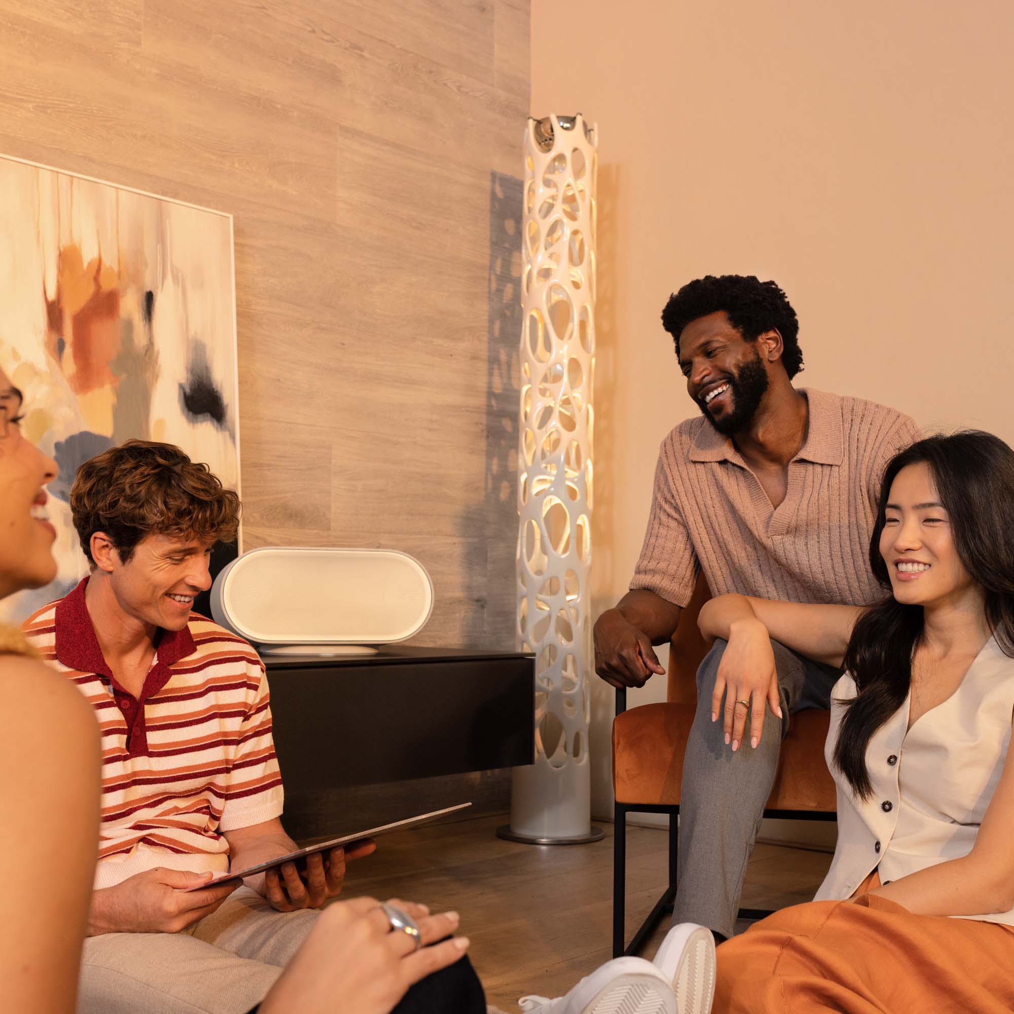 Denon Home 600 wireless speaker in stone color, showcasing its sleek design and compact size for premium audio.