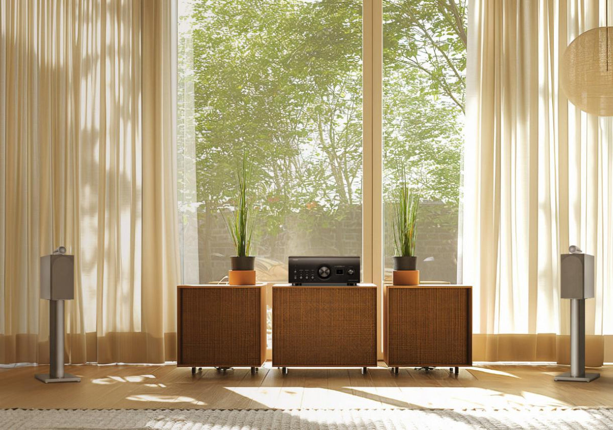 Black Denon PMA-3000NE stereo amplifier with control knobs and digital inputs, showcasing its sleek, modern design.