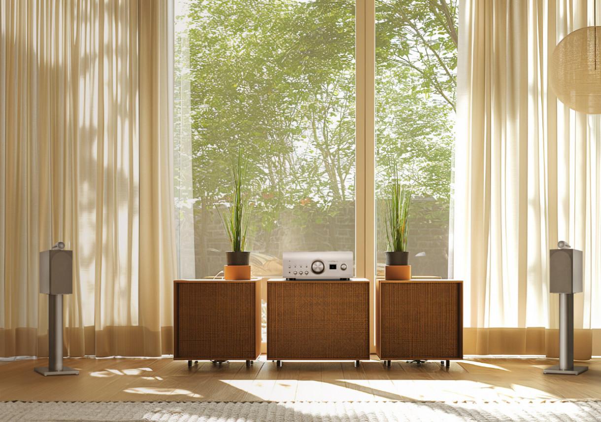 Denon PMA-3000NE stereo integrated amplifier in silver with control knobs and input ports on the front panel.