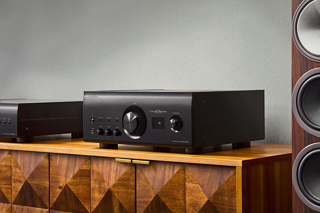 Denon PMA-3000NE stereo amplifier with sleek black design, multiple audio input options, and control knobs on the front panel.