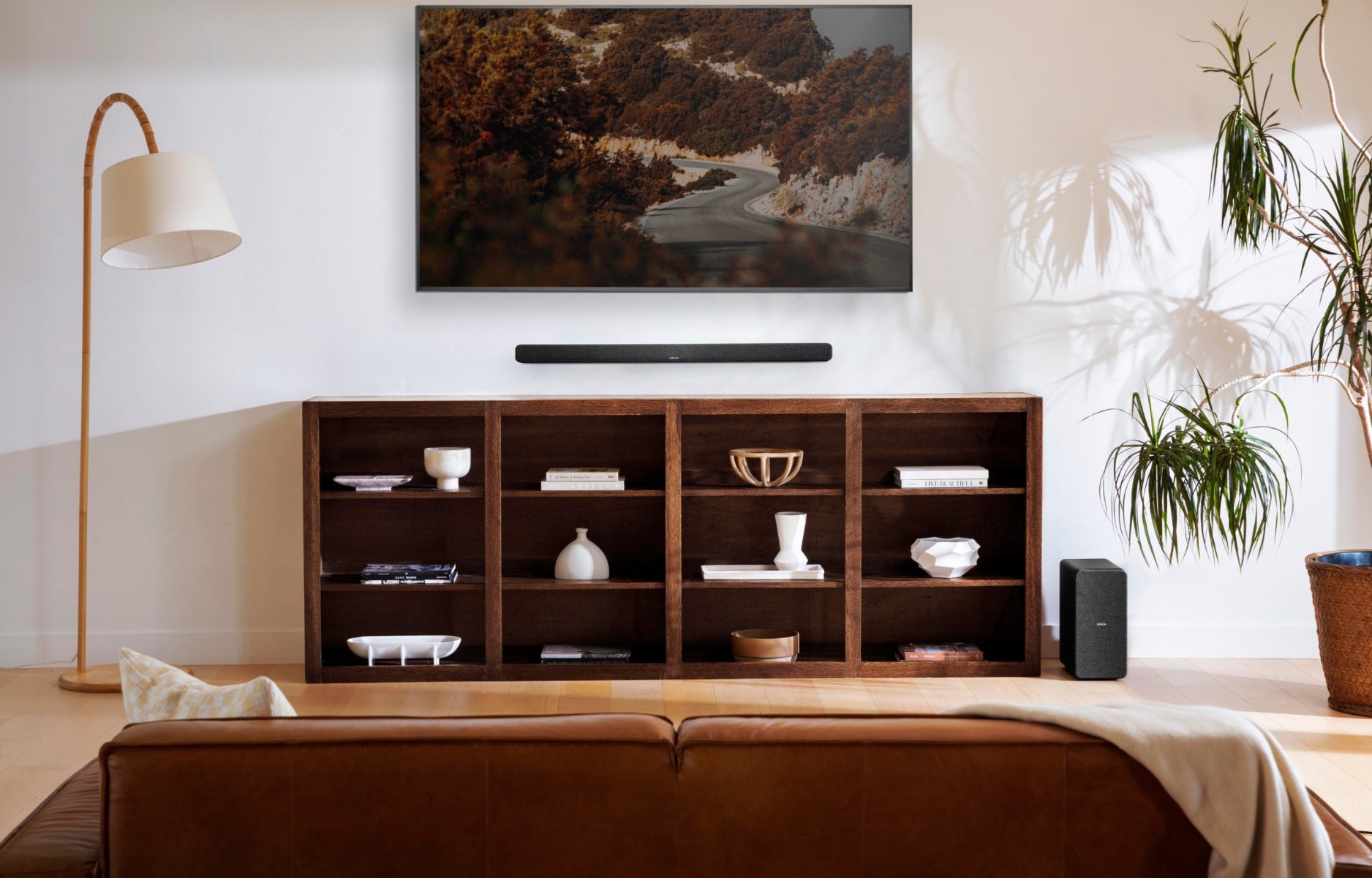 Denon DHT-S517 soundbar with sleek black design and multiple speaker drivers for enhanced TV audio.