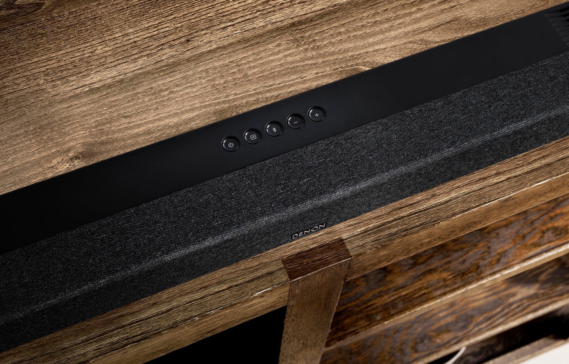 Denon DHT-S517 soundbar with sleek black design and remote control for enhanced TV audio and home entertainment.
