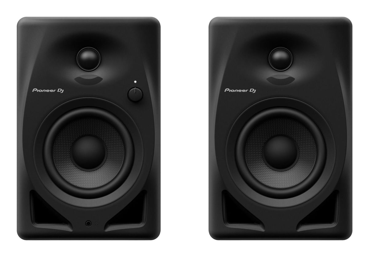 Pioneer DJ DM-40D desktop speakers shown from the front, featuring black enclosures and control knobs for audio adjustment.