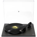 Rega Planar 1 Plus turntable with wooden plinth and tonearm, close-up view highlighting the classic audio equipment design.
