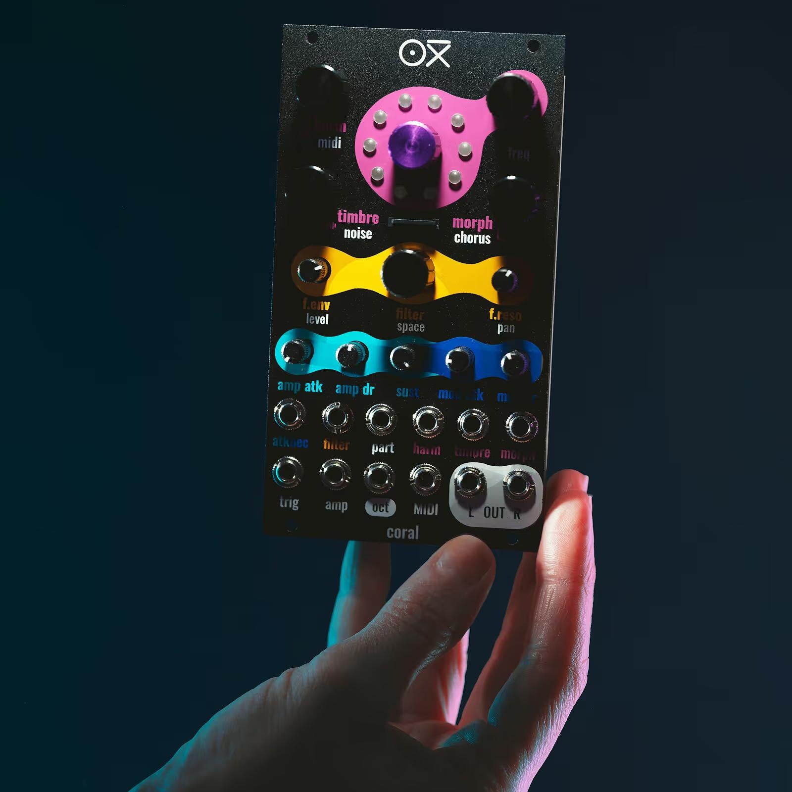 OXI Instruments Coral semi/modular synthesizer with engine modules, featuring colorful patch cables and control knobs.