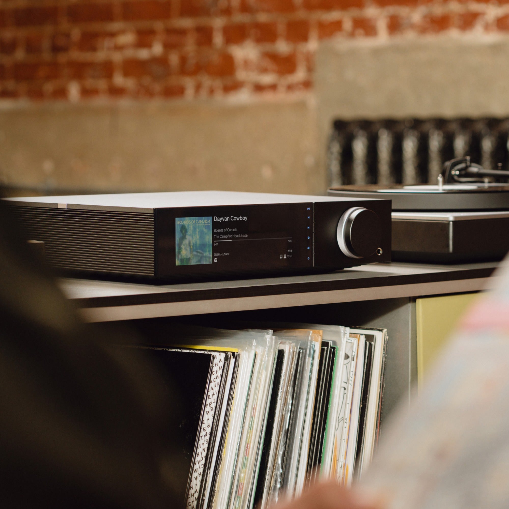 Cambridge Audio Evo 300 on a shelf with a vinyl record collection in a home listening room