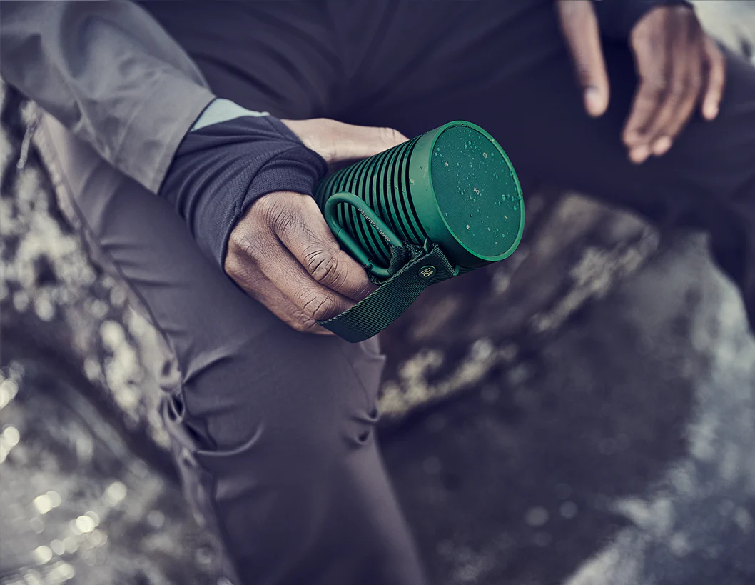 Bang & Olufsen Beosound Explore portable speaker in a mosaic design, showing its rugged exterior and compact size.