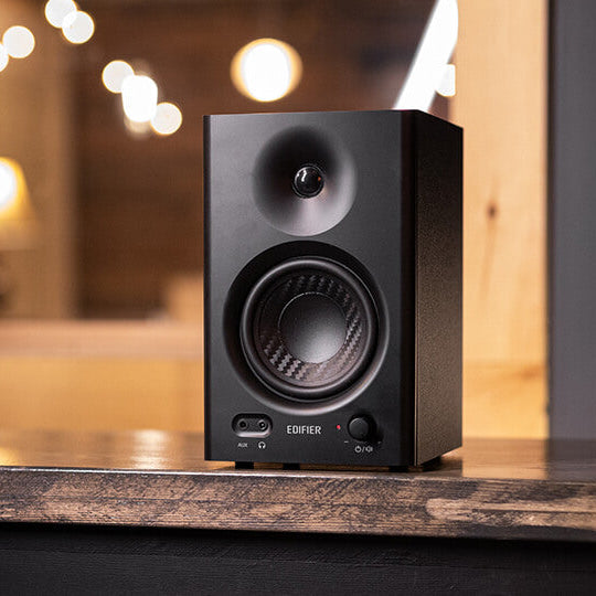 Edifier MR4 desktop speakers with black woodgrain finish, compact design, and adjustable controls on the front panel.