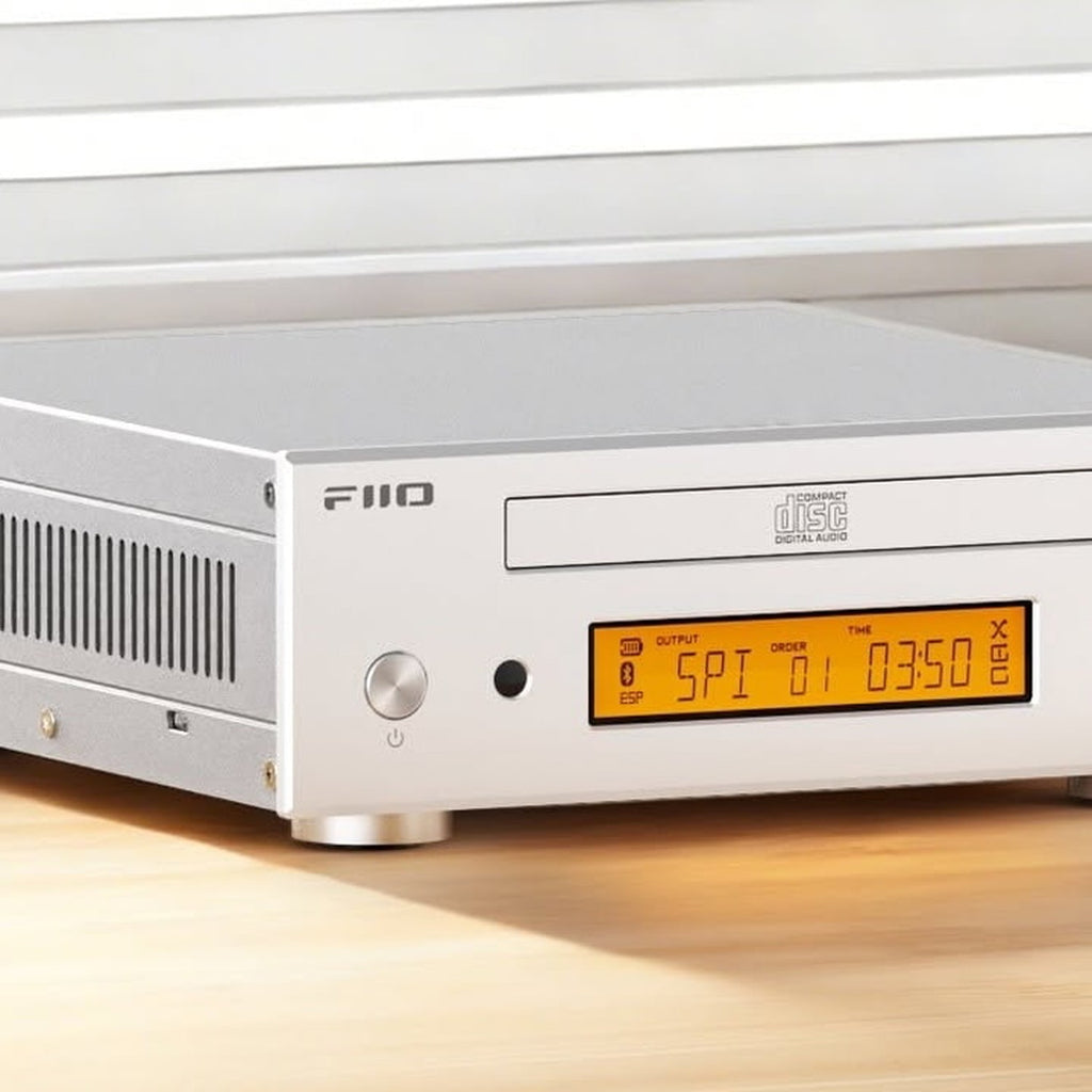 FiiO DP11 silver CD player on a wooden desk, close-up of the display