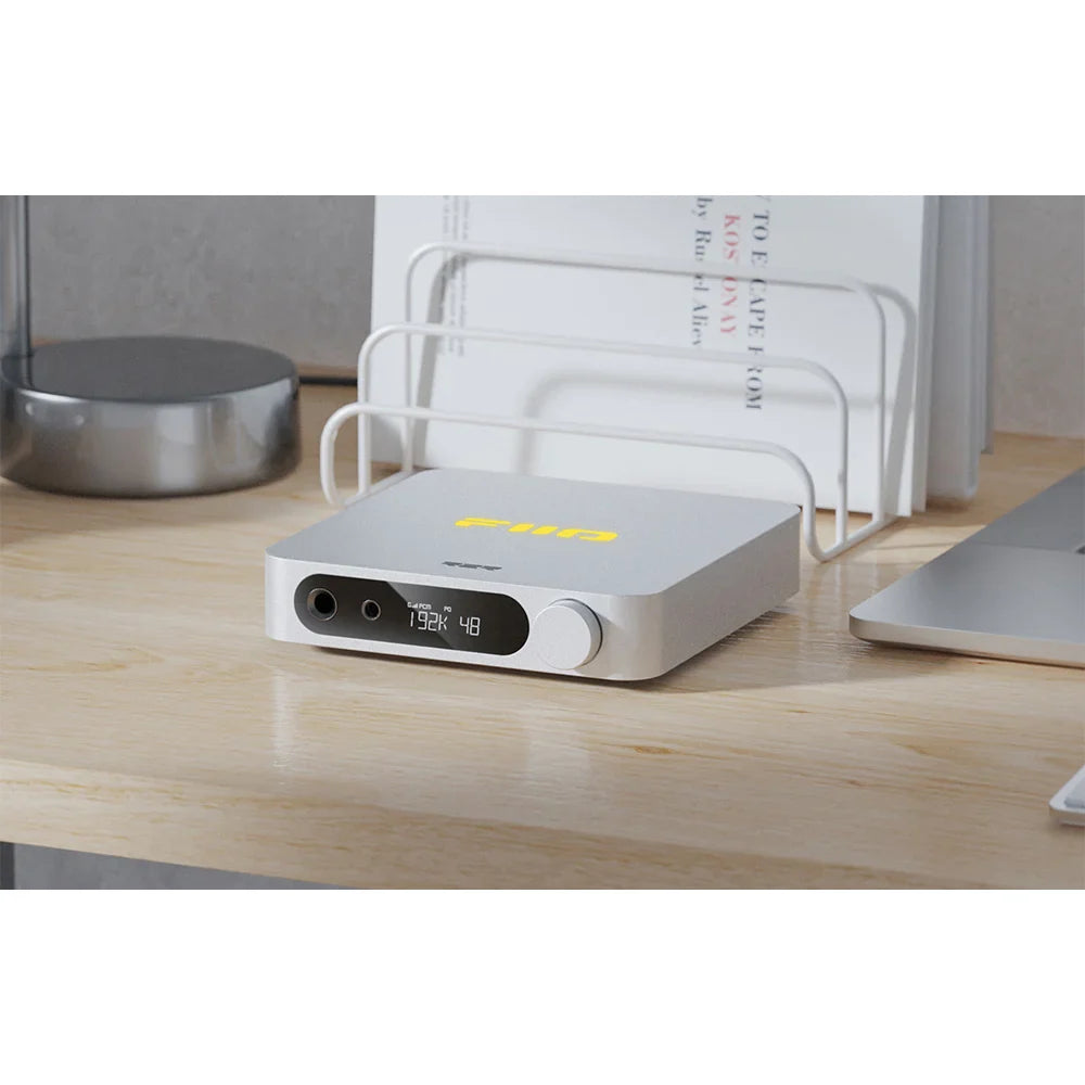FiiO K11 R2R headphone amplifier and DAC with sleek black design and multiple input options, featuring a digital display screen.