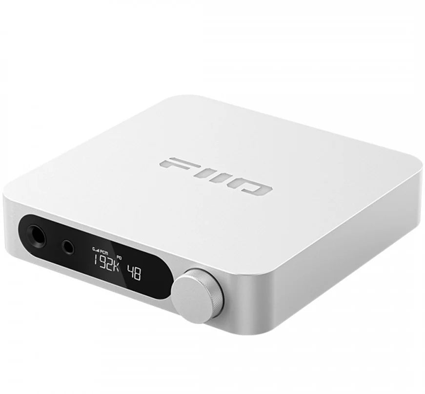 FiiO K11 silver headphone amplifier and DAC with sleek design, multiple input options, and digital audio output.