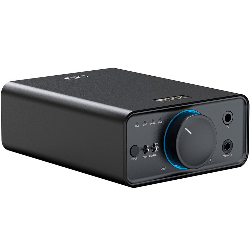 FiiO K7 headphone amplifier and DAC with sleek black design, multiple input ports, and control knobs on top.