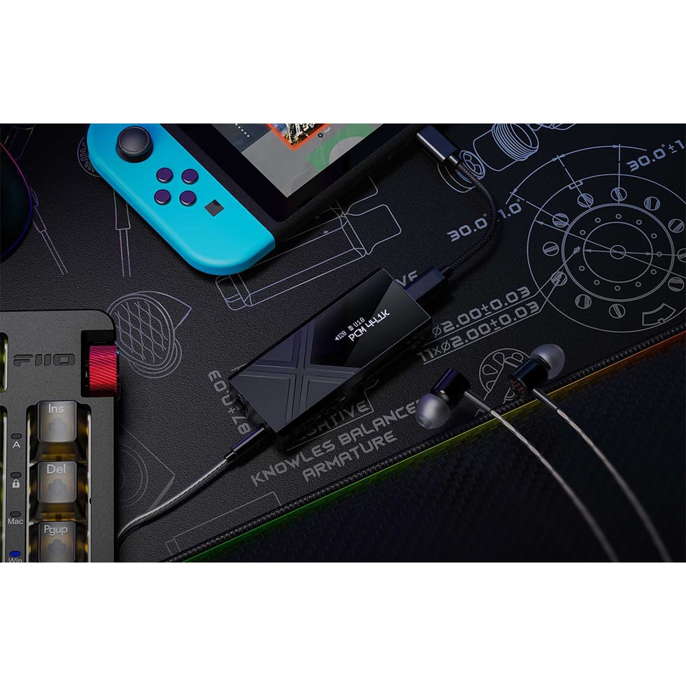 FiiO KA17 headphone amplifier and DAC with sleek black design and multiple input ports for high-quality audio.