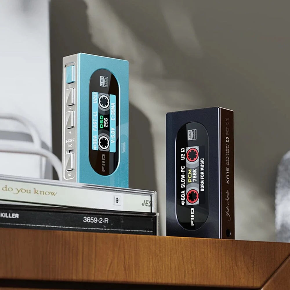 FiiO KA15 portable headphone amplifier and DAC with dual CS43198 chips and 10-band PEQ displayed on the device.