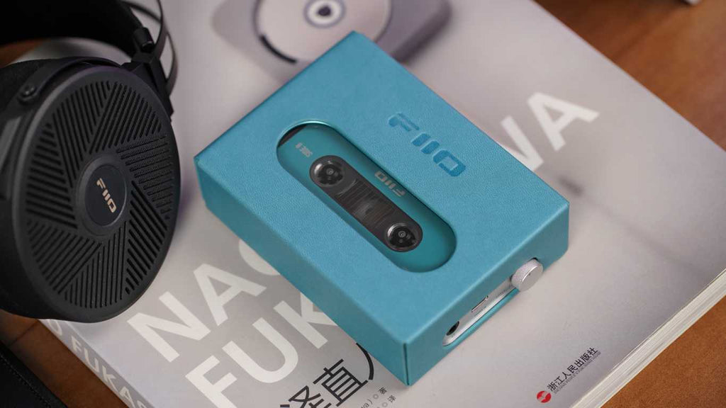 FiiO CP13 portable music player with sleek black design, digital display, and control buttons for high-quality audio playback.