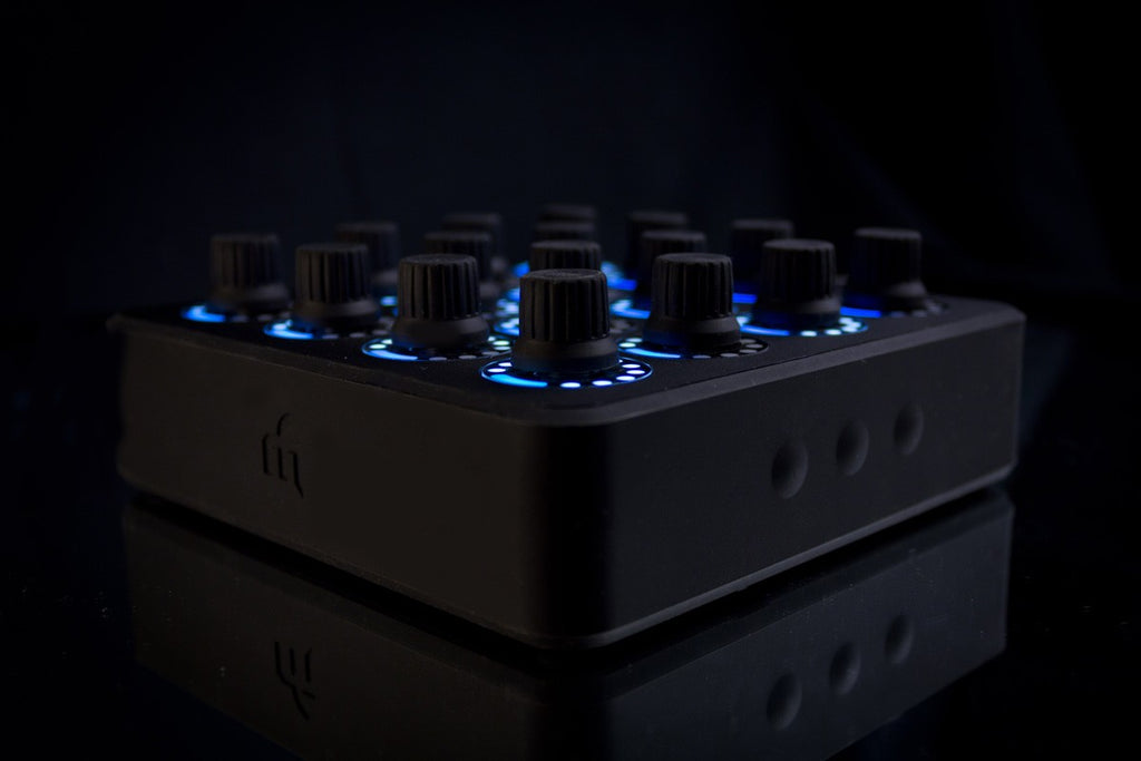 DJ TechTools MIDI Fighter Twister MIDI controller with colorful rotary knobs and buttons, front-angle view.