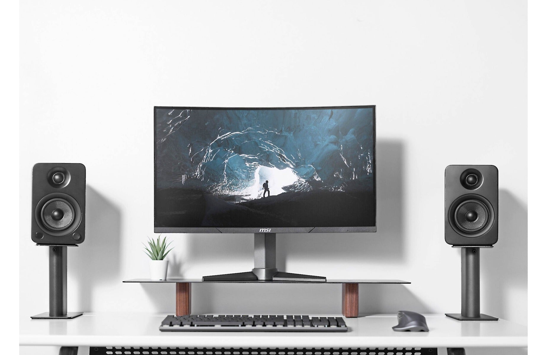 Kanto Audio SP9 9-inch desktop speaker stands supporting compact speakers on a desk with a sleek black finish.