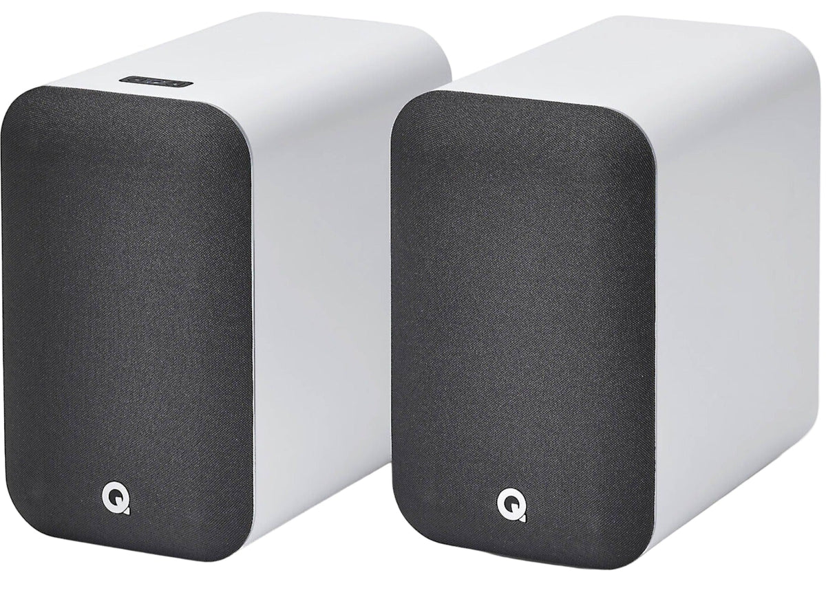 Q Acoustics M20 HD wireless speakers shown with black finish and modern design, featuring control buttons on the front panel.
