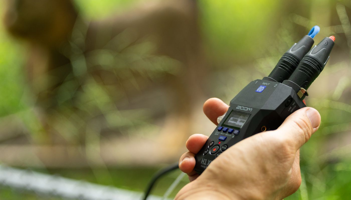 Zoom H1 XLR digital recorder with XLR input and compact design, shown in a close-up image highlighting its controls and ports.