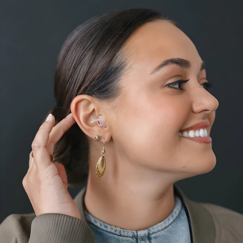 Girl wearing EarPeace Music Earplugs for hearing protection, designed to reduce loud sounds while enjoying music.
